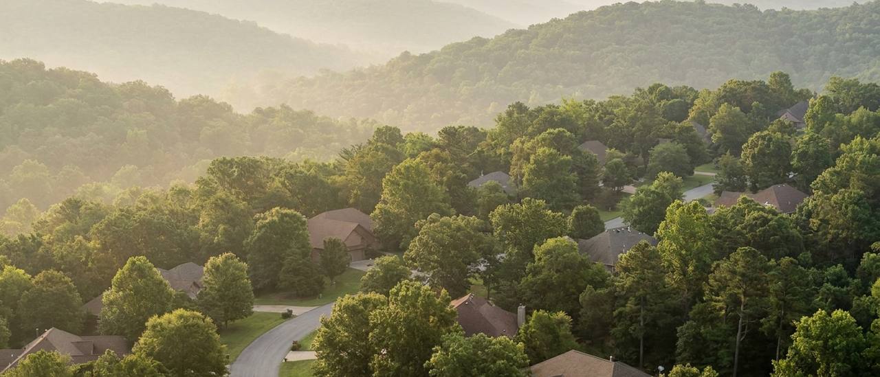 Wooded Ozark hillside neighborhood terrain typical of Bentonville and Bella Vista, Arkansas